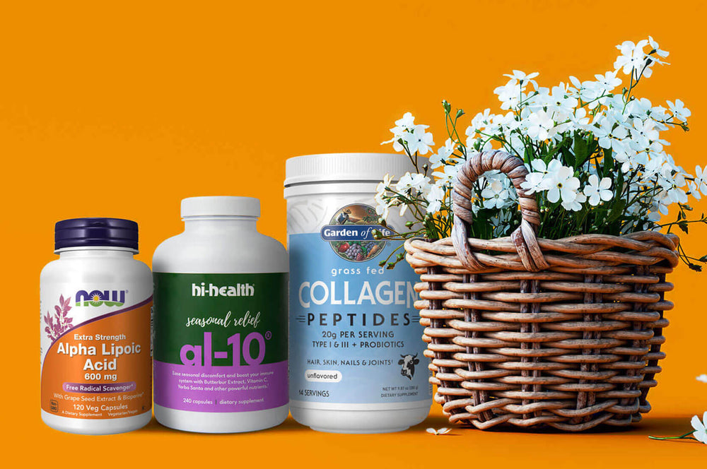 Three supplement bottles are arranged next to a flower basket, set against a solid orange background.